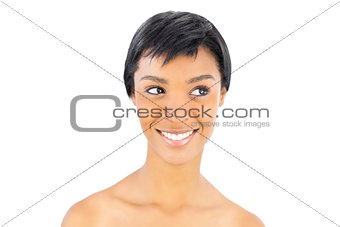 Cheerful black haired woman posing looking away