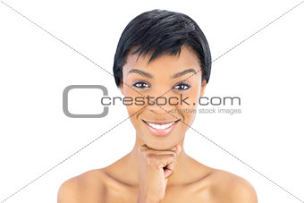 Joyful black haired woman posing looking at camera