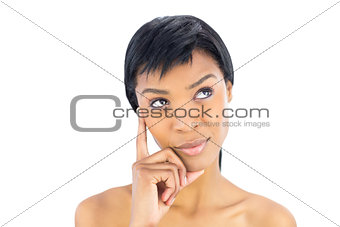 Wondering black haired woman posing looking away