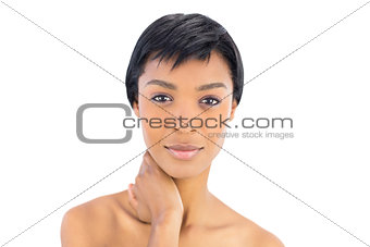 Thoughtful black haired woman posing looking at camera