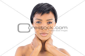 Frowning black haired woman posing looking at camera