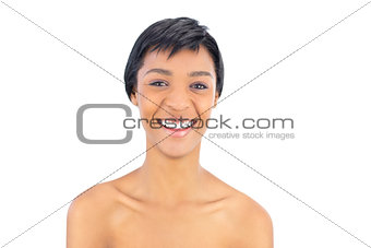 Laughing black haired woman looking at camera