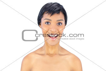 Surprised black haired woman smiling at camera