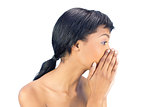 Attractive black haired woman covering her mouth with both hands