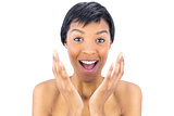 Joyful black haired woman raising her hands