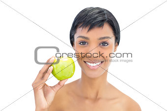 Content black haired woman holding an apple