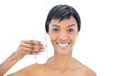 Cheerful black haired woman holding a glass of water