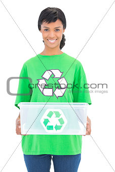 Smiling black haired ecologist holding a recycling box