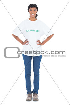 Happy black haired volunteer posing with hands on the hips