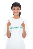 Cheerful black haired volunteer giving thumbs up