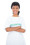 Content black haired volunteer posing with crossed arms