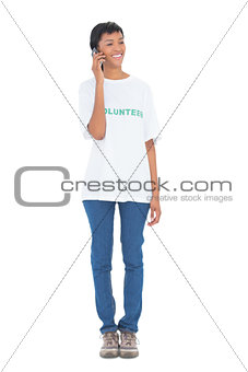 Cute black haired volunteer calling someone with her mobile phone