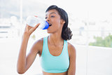Content fit woman drinking a bottle of water