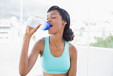 Attractive fit woman drinking a bottle of water