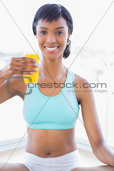 Relaxed fit woman enjoying a glass of orange juice