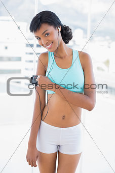 Playful sportswoman listening to music