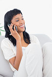 Attractive black haired woman in white clothes phone calling