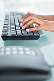 Close up of a businesswoman typing on a keyboard
