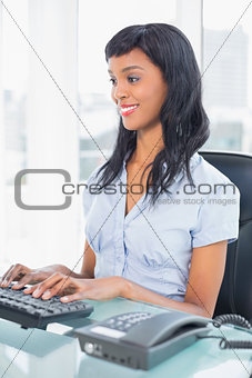 Content businesswoman typing on a keyboard