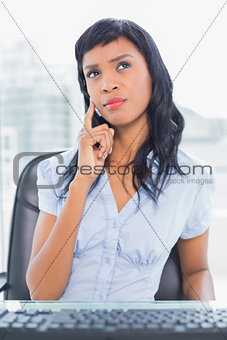 Concentrated businesswoman thinking and looking away