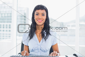 Lovely businesswoman sitting at her desk