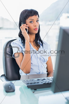 Unsmiling businesswoman having a phone call