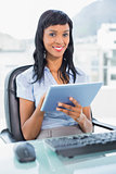 Cute businesswoman using a tablet pc