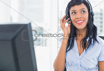 Attractive operator adjusting her headset