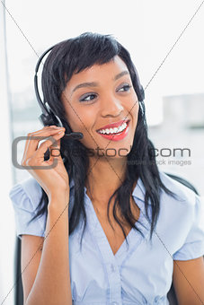Pleased operator adjusting her headset