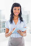 Calm businesswoman using a tablet pc
