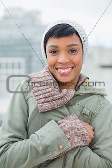 Lovely young model in winter clothes posing and looking at camera