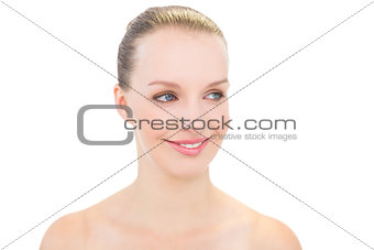 Smiling pretty blonde model posing looking away
