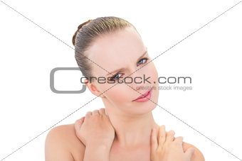 Pretty blonde model holding her painful neck