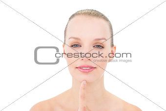 Content pretty blonde model touching her chin