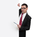 smiling businessman showing with pointer to blank placard