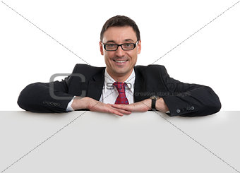 smiling young business man showing blank signboard