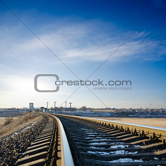 railroad to horizon under deep blue sky in sunset