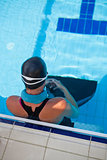 Female swimmer at pool edge