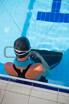 Female swimmer at pool edge