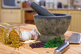 Kitchen scene showing a pestle and mortar and spices
