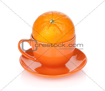 Ripe orange in tea cup