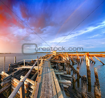 Old wooden pier at sunset. 