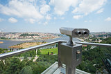 Binoculars on an aerial viewing platform over city