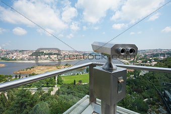 Binoculars on an aerial viewing platform over city
