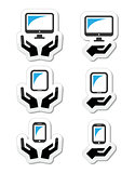 Hands with computer, tablet, mobile or cell phone icons