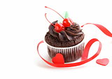festive (birthday, valentines day) cupcake decorated with chocolate ganache and cherries
