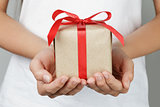 young female hands holding gift