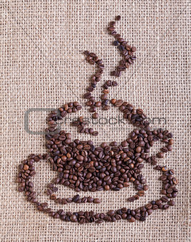 Coffee cup made of beans - on burlap background