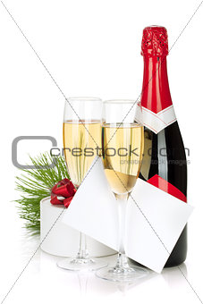 Champagne, christmas gift and empty greeting card
