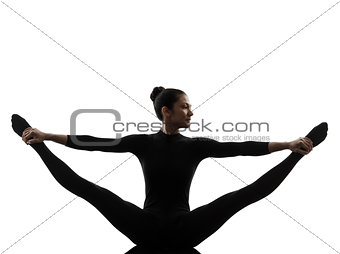 woman exercising gymnastic yoga  stretching split  silhouette